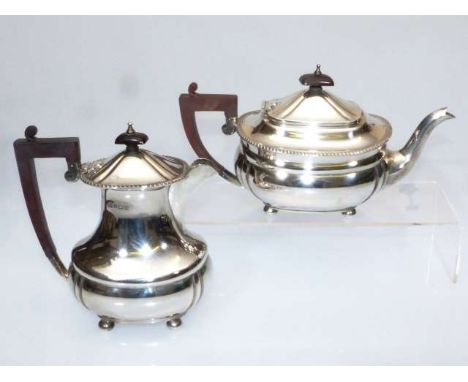 A SILVER TEAPOT
Elkington & Co, Sheffield 1970
With gadrooned rim and bun feet; together with a silver hot water jug, Elkingt