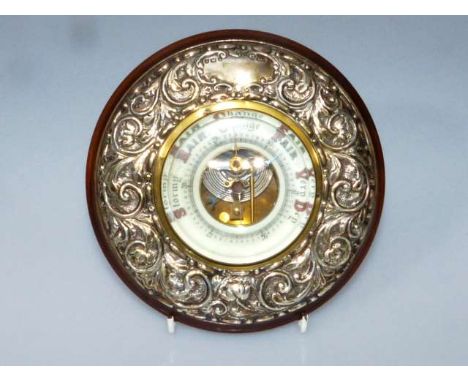 AN EDWARDIAN SILVER-MOUNTED MAHOGANY WHEEL BAROMETER
Maker JHW, Birmingham 1903
The silver repousse with scrolling foliage.
D