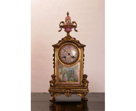 A FRENCH ORMOLU AND PORCELAIN MANTEL CLOCK
19th Century
The case with urn finial and cast with putti, two-train movement stri