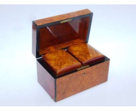AN EARLY 19TH CENTURY BURR ELM TEA CADDY
Of rectangular form with ebonised edges, the interior with twin canisters with hinge
