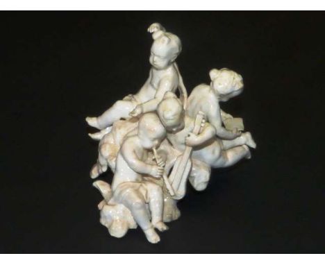 A CONTINENTAL WHITE-GLAZED PORCELAIN FIGURE GROUP
Probably Italian and 18th Century
Modelled as putti playing musical instrum