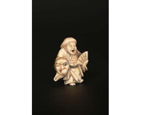 A JAPANESE IVORY NETSUKE
Carved as a mask seller with protruding moving tongue, signed.
5cm