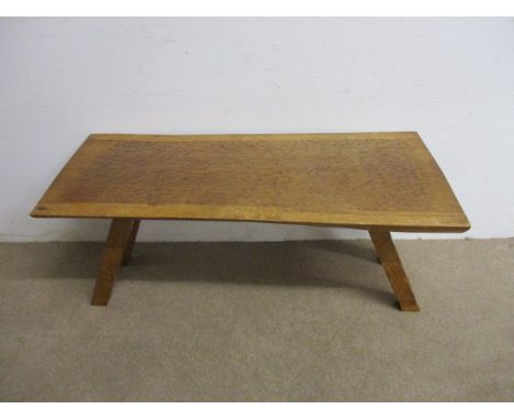 A 1960s Alan Granger 'Acornman', apprentice to Robert Thompson 'Mouseman', an oak coffee table having a chip carved top raise