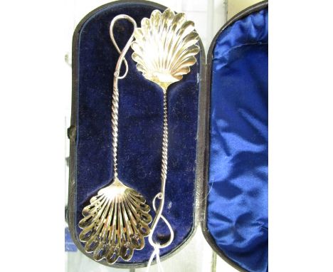 A Victorian silver serving spoon set comprising a serving spoon and sugar sifting ladle with shell shaped bowls on twisted st
