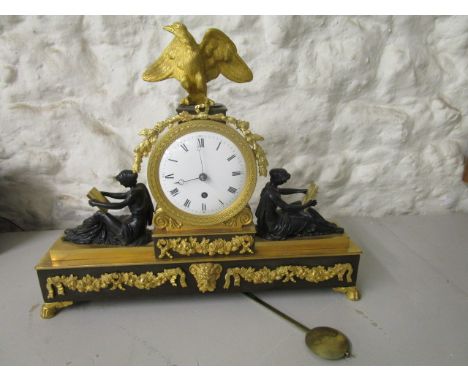 A late 19th Century French patinated and gilt brass mounted mantle clock in the Empire period style, the figures emblematic o