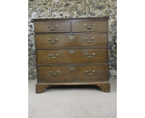 An early 18th century oak chest of two short and three graduated long drawers, raised on bracket feet, 37h x 37 x 20w