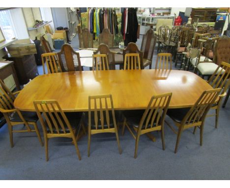 A 1970s Danish Gudme teak Mobelfabrik extending dining table, raised on twin columns of three angular legs, united by a stret