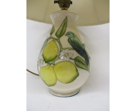 A Moorcroft pottery Lemon Tree pattern table lamp of ovoid form on a splayed foot, 8 h with a fabric shade