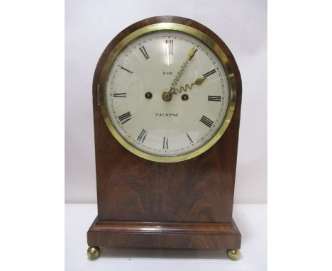 A Regency mahogany cased bracket clock having an arched top, brass fretwork panelled sides on a plinth and ball foot with a R