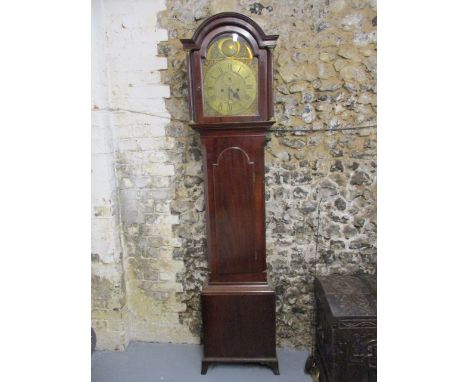 A George III mahogany longcase clock, the hood having an arched top with turned columns, over a door and box base, raised on 