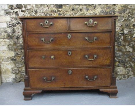 A George III mahogany chest of four graduated long drawers, with brass bail handles and fluted, quadrant flanks, raised on og
