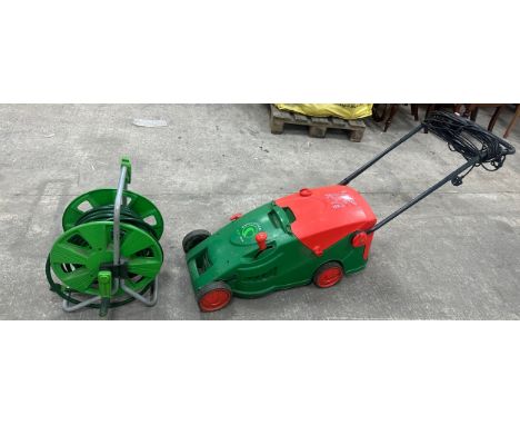 Evolution 1000 watt lawn mower and a hose pipe
