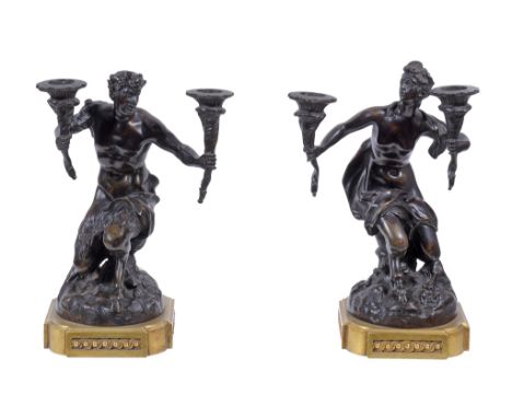 A pair of Continental patinated and gilt bronze mounted twin light figural candelabra,   mid 19th century, cast as male and 