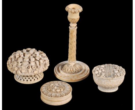  Four items of Continental carved ivory,   19th century, comprising; a columnar taper-stick, 15.5cm high;   a box and cover a