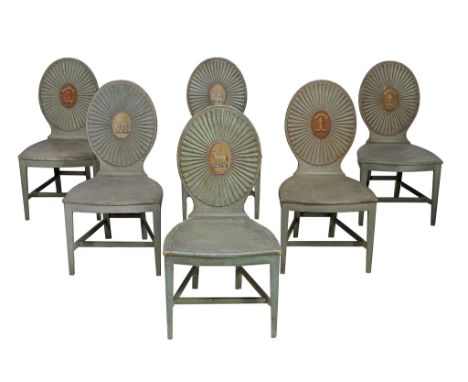 A set of six George III painted hall chairs, circa 1780, the oval backs with a radiating design centred on oval cartouches wi