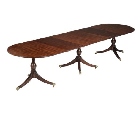  A mahogany triple pedestal extending dining table, in George III style,   20th century, the rectangular top with rounded end