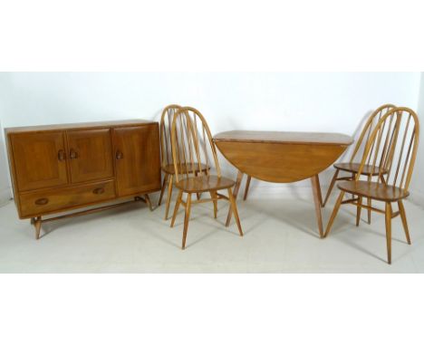 An Ercol dining suite, circa 1960's, comprising circular elm and beech drop leaf dining table, No 384, 130 by 75 by 75.5cm hi