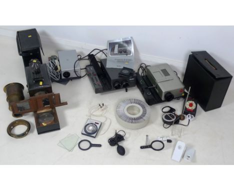 A group of photographic projectors, comprising a Leica Pradovit P600 projector and two Rolleivision projectors, together with