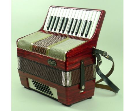 A Bell 32 Bass piano accordion, with ruby red casing, complete with straps and case, 33.5 by 39.5cm.