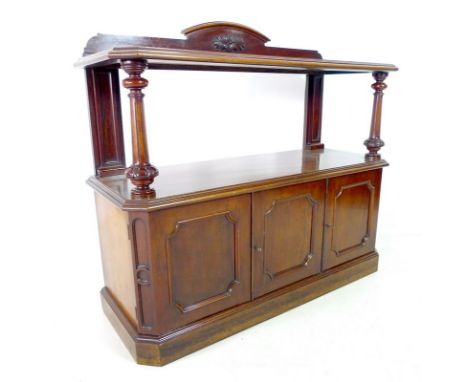 An early Victorian mahogany buffet with canted corners, shaped upstand on an upper tier shelf, carved, turned and fluted fron