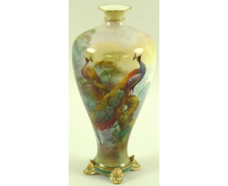 A Royal Worcester vase of baluster form, the flared neck with gilded rim and collar, the body painted with a peacock and peah