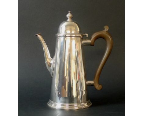 A silver coffee pot, conical form with ribbed foot and compressed globular finial, wooden handle, London 1980, Nayler Brother