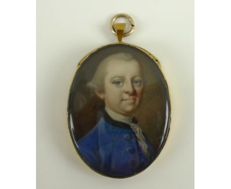 An 18th century portrait miniature of a gentleman in a blue coat with lace to the collar, in an oval clasp setting, 2.5 by 3.