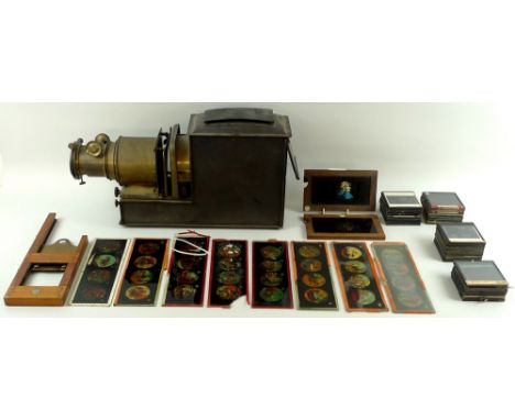 A Victorian brass and black painted metal magic lantern projector, with a variety of slides, a Thornton-Pickard wooden slide 