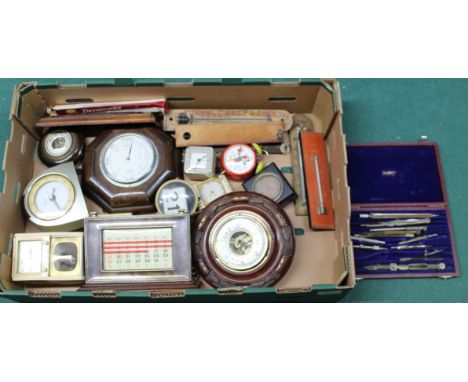 A selection of aneroid barometers and clocks, a plated desk calendar, thermometers, cased drawing instruments and a German Mi