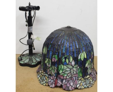 A large Tiffany style table lamp with a large multicoloured stained glass bell shaped shade with scalloped edge