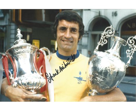 Football Autographed 12 x 8 photo, a superb image depicting FRANK McLINTOCK posing with the First Division trophy and the FA 