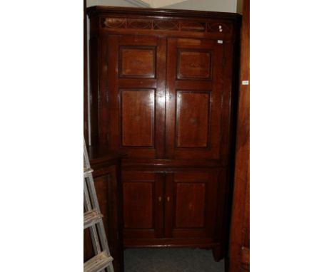 A good George III oak, mahogany and marquetry decorated free-standing corner cupboard, late 18th century, the dentil cornice 