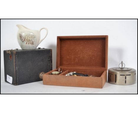 A collection of items to include a vintage Midland Bank money box with working key, Kodak box brownie, a compass, Concorde bo