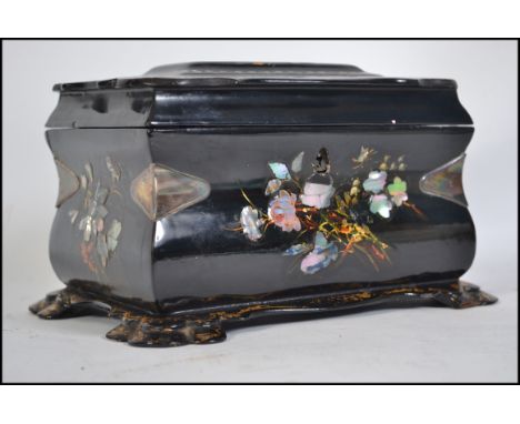A 19th Century Victorian papier mache tea caddy with original interior, decorated with hand painted floral sprays and mother 