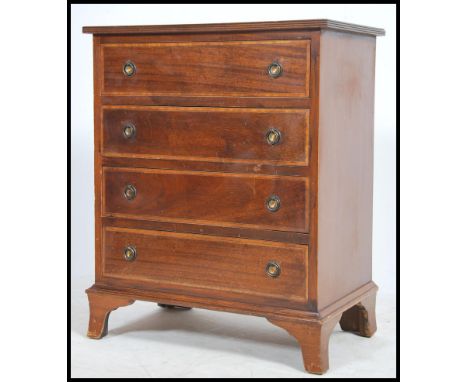 An Edwardian mahogany inlaid bachelors chest of drawers being raised on bracket feet having a series of short and deep drawer