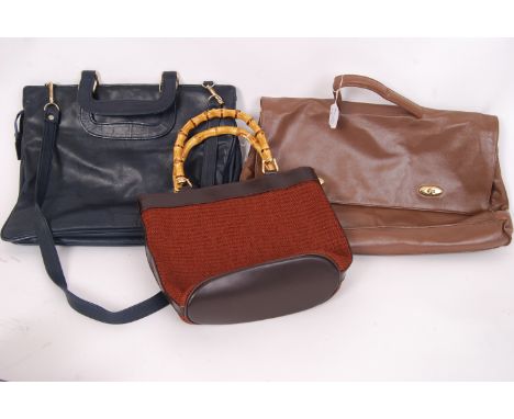 A collection of three vintage ladies bags / handbags. One navy leather attache style bag with various internal compartments a