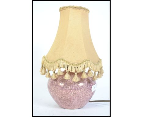 A 1930's lustre ceramic table lamp of bulbous form marked to the base CH France. Complete with the shade. 37cms high