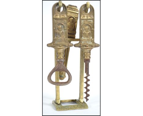 A vintage brass William Shakespeare inspired drinks compendium consisting of cork screw, bottle opener etc all on a stand. Me