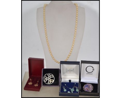 A group of jewellery to include a faux pearl necklace with silver tone metal clasp, a pale blue stone necklace and earring se