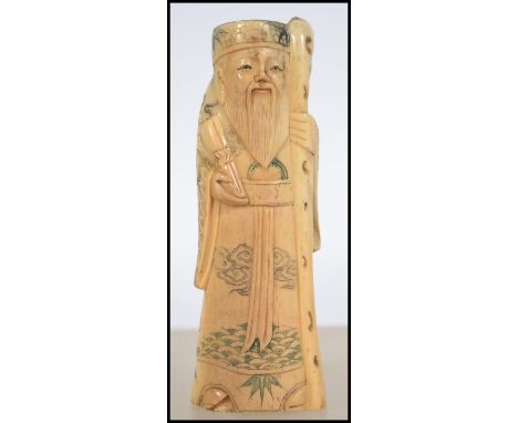 A 19th century Chinese / Japanese carved okimono bone figurine of an elder having a character seal mark to the base. Measures