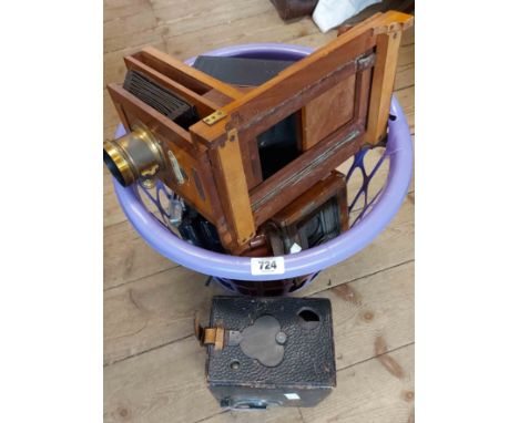 A basket containing a quantity of cameras including Corona wooden plate camera, Polaroid land camera, etc.
