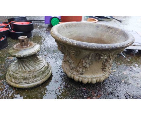 A large cast concrete planter of urn form with moulded decoration, set on a pedestal base