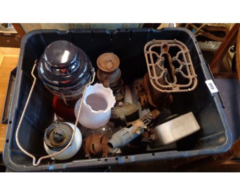 A crate containing a quantity of lamps and other items including Tilley style lamp, a hurricane lamp, enamel paraffin stove, 