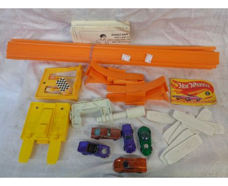 A vintage Mattel Hot Wheels race set with four cars and a quantity of track