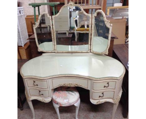 A 1.23m vintage French style kidney shaped kneehole dressing table with parcel gilt and cream finish, triple mirror, drawers 