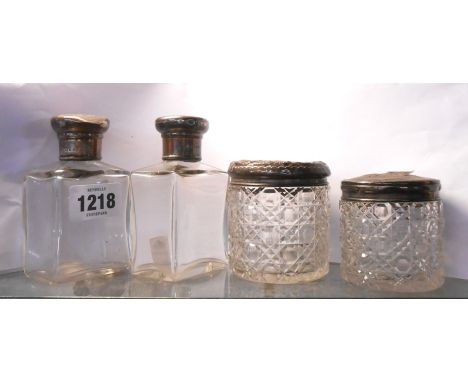 A pair of silver topped cut sided glass scent bottles - sold with two hobnail cut dressing table trinket boxes with embossed 