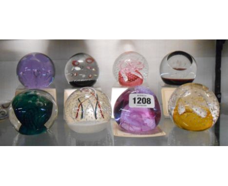Eight Caithness glass paperweights four with original display stands including limited and unlimited examples