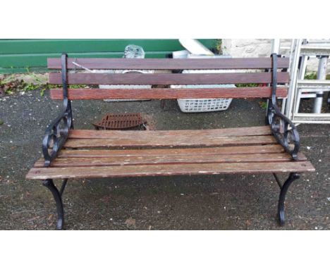 A 1.22m garden bench with slatted wooden back and seat, set on cast iron scroll ends