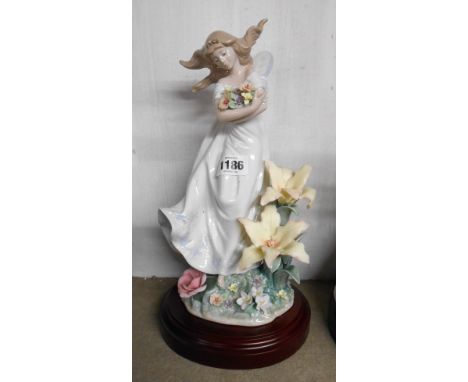 A boxed Lladro porcelain figurine 'Mystical Garden' set on wooden base