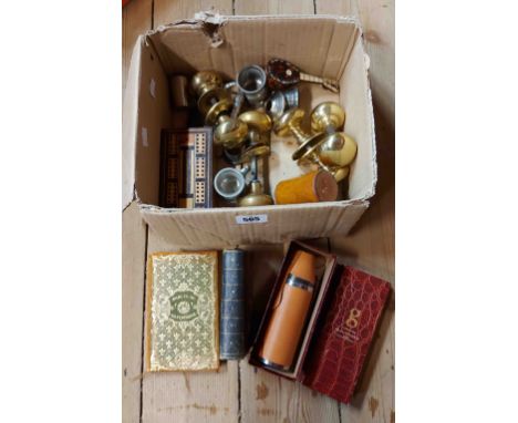 A box containing a quantity of collectable items including brass door handles, inlaid wooden cribbage board, etc.